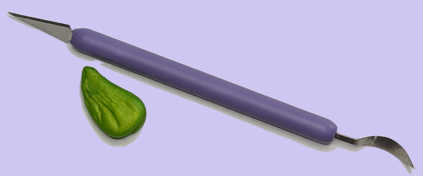 Sucker plucker unsheathed with purple handle and green top