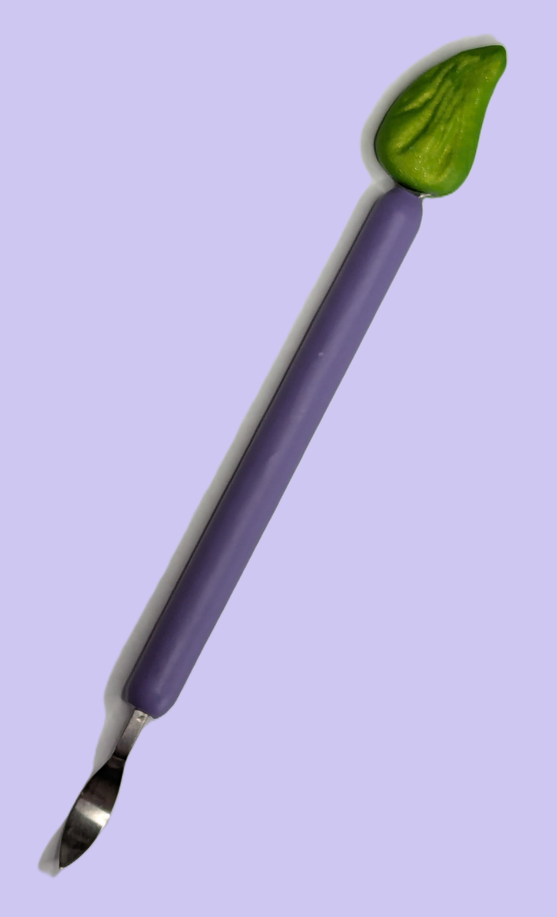 Sucker plucker with purple handle and green top